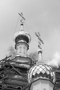cupolas of orthodox temple with sky at background. black and white.