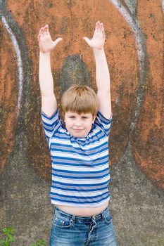 little boy with graffiti at background