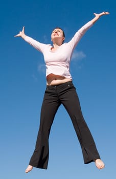 the girl jumps with sky at background