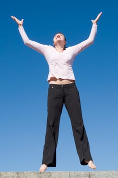 the girl jumps with sky at background