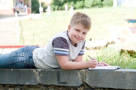 The little boy writes to writing-books