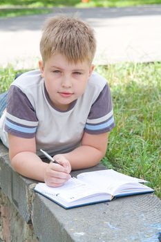 The little boy writes to writing-books