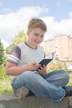 The little boy writes to writing-books