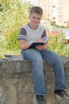 The little boy writes to writing-books