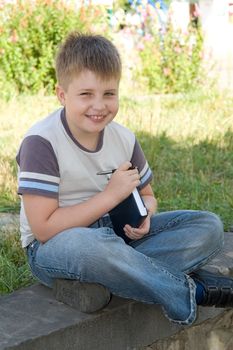 A smiling little boy with the book