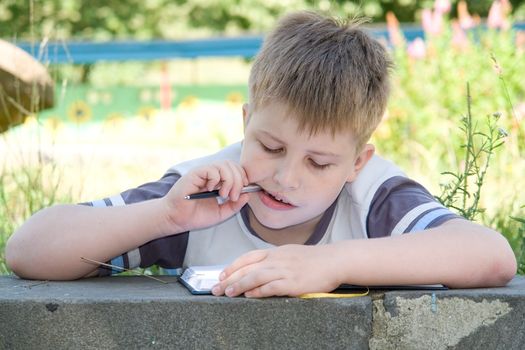 The little boy writes to writing-books