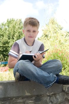 The little boy writes to writing-books