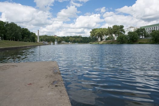 City quay with cloudy sky at background