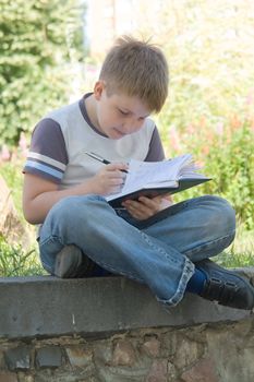 The little boy writes to writing-books