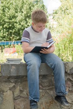 The little boy writes to writing-books