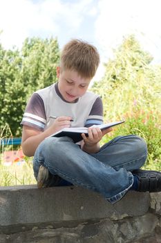 The little boy writes to writing-books
