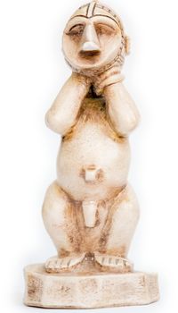 Small African figurine on a white background