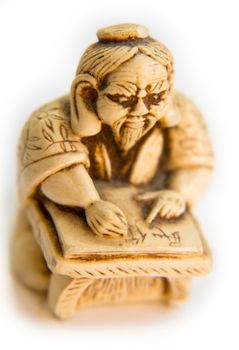 Small Chinese figurine on a white background