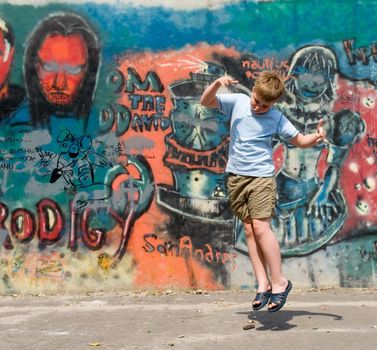 The jumping child with graffiti at background