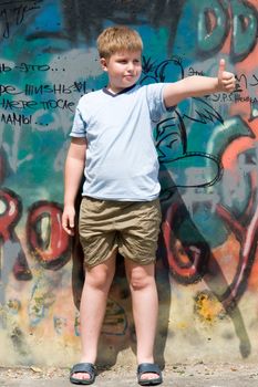 A smiling child with graffiti at background