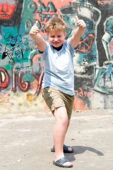 A smiling child with graffiti at background