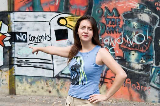 The beautiful girl specifies an inscription "no coments" on a wall