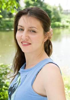 portrait of a beautiful woman with river at background