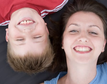 Mum and the son smile. A close up. The top view.