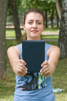 girl with book in park
