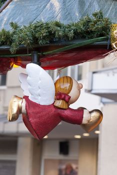 Flying angel holding heart at christmas market in Germany