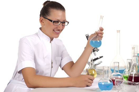 young woman scientist  chemist mixes the liquid in the tubes