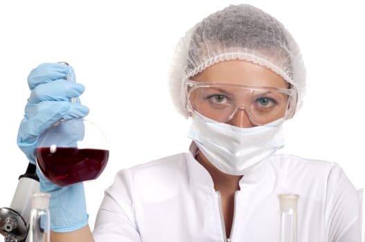 young woman scientist  chemist mixes the liquid in the tubes