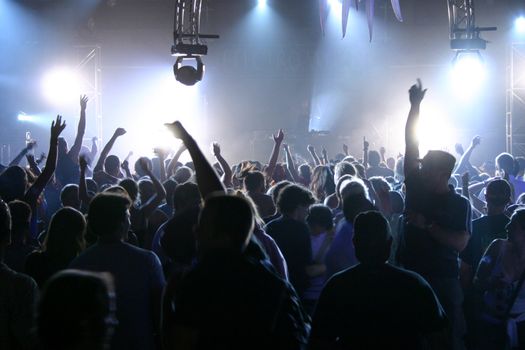 People jumping and dancing during a live concert