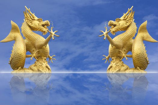 golden chinese dragon statue on blue sky background