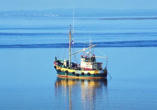 Old fishing boat anchored near Tadousac - Canada