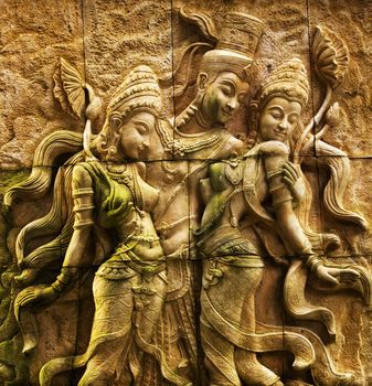 Traditional Thai stone carving on a wall - travel and tourism.