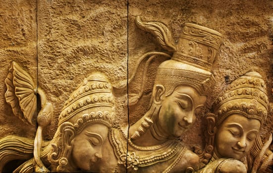 Traditional Thai stone carving on a wall - travel and tourism.
