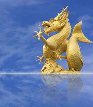 golden chinese dragon statue on blue sky background
