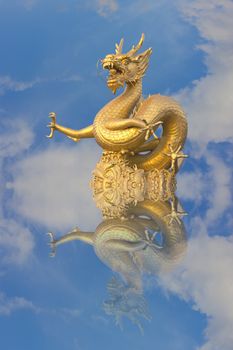 golden chinese dragon statue on blue sky background