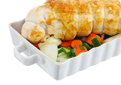 Crop of bound grilled turkey breast with  vegetables on baking pan isolated on white background