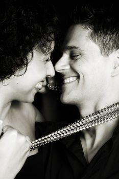 Beautiful young couple laughing with their faces close to one another