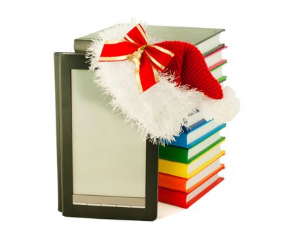 Electronic book reader wearing Santa's hat with stack of books