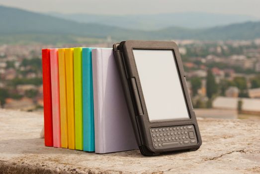 Row of colorful books with electronic book reader