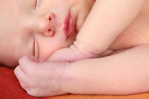 Newborn baby sleeping on a soft blanket