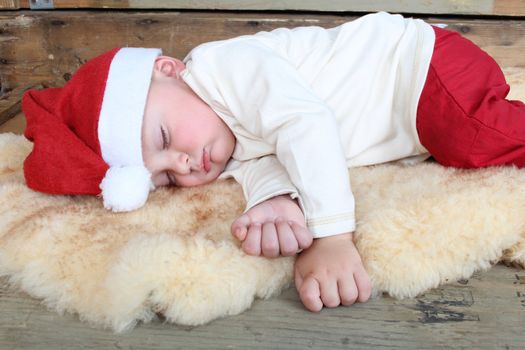 Baby boy wearing a christmas hat sleeping sound