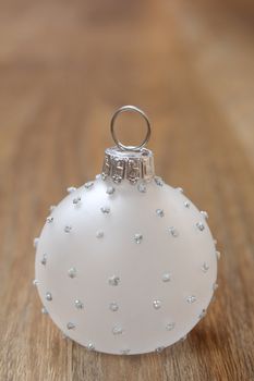 Glass christmas ball decoration on a wooden floor