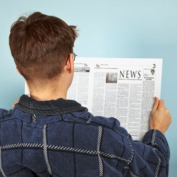 A man reading the news in the newspaper