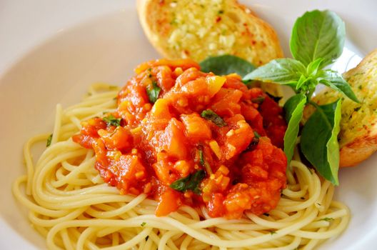 pasta with tomato sauce and meat and garlic bread