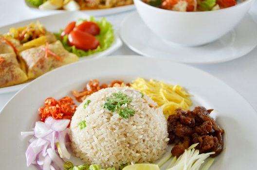 Mixed cooked rice with shrimp paste sauce and fresh vegetable , Thai food on table