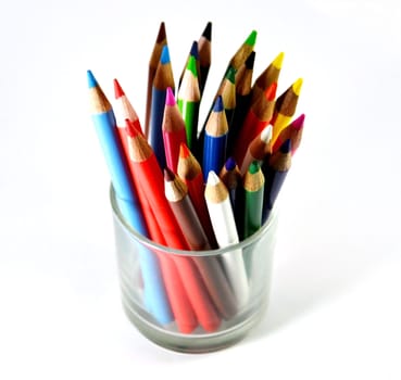 colored pencils in a glass cup