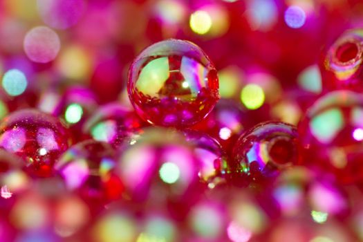 red bead in close up view with bokeh back and foreground