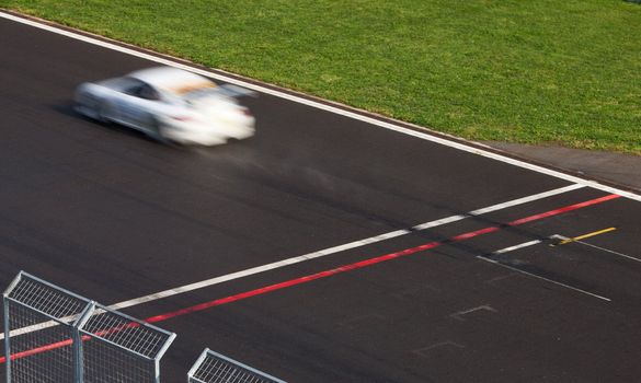 Race car passing finnish Line.