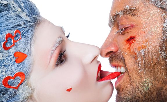 Close-up of male biting woman's lip, both faces covered with frost