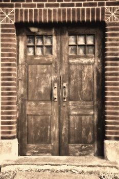 Door of an old building in Europe with sepia tones