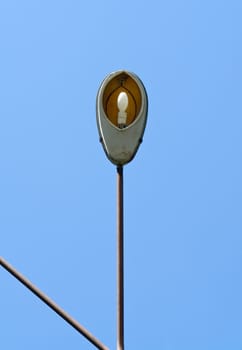 Old street lantern with sky at background.